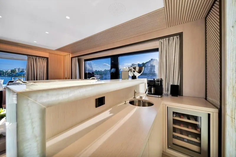 Slide: The Image of Luxurious interior of 2024 Baglietto DOM 133 yacht with modern kitchenette and wine cooler. - 53