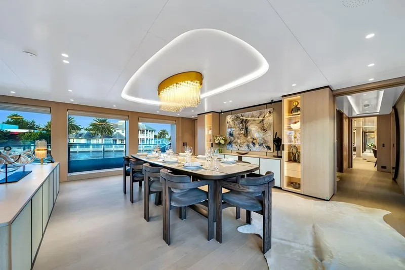 Slide: The Image of Luxurious dining area on 2024 Baglietto DOM 133 yacht with elegant decor and large windows. - 62