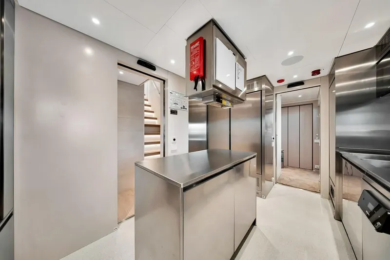 Slide: The Image of Modern kitchen interior on 2024 Baglietto DOM 133 yacht, featuring sleek stainless steel design. - 68