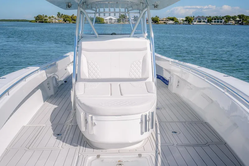 Slide: The Image of 2020 Contender 44ST boat with white seating, step hull design, on calm water. - 13