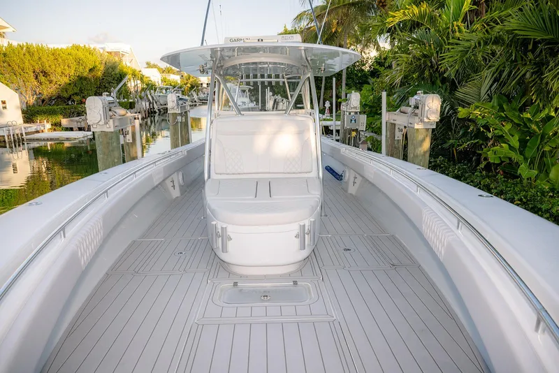 Slide: The Image of 2020 Contender 44 ST boat docked, featuring spacious deck and seating area. - 25