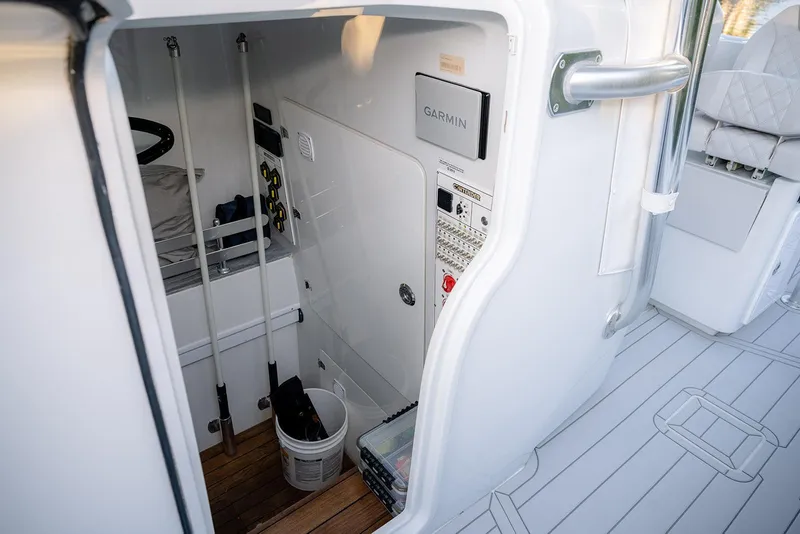 Slide: The Image of Interior view of a 2020 Contender 44 ST boat, featuring storage and control panel. - 28