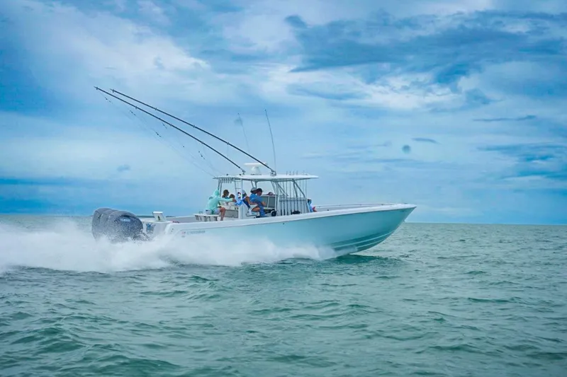 Slide: The Image of 2020 Contender 44 ST boat speeding on open water under a cloudy sky. - 3