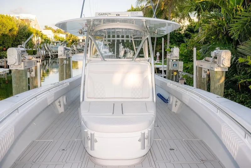 Slide: The Image of 2020 Contender 44 ST boat docked, featuring sleek design and spacious seating area. - 30