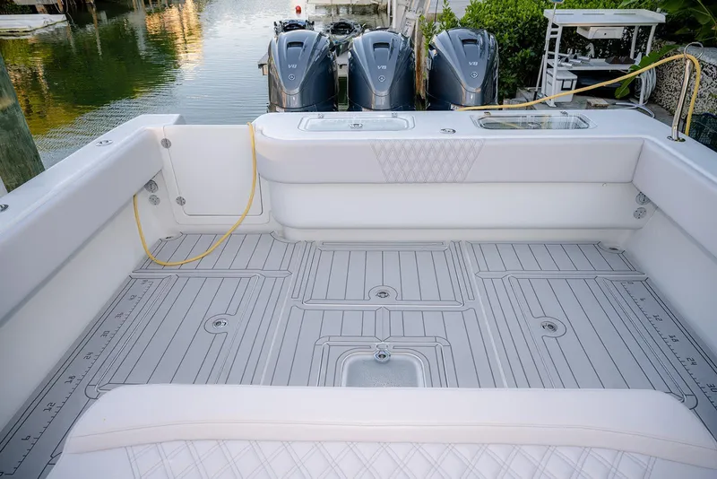 Slide: The Image of 2020 Contender 44 ST boat deck with triple V8 engines, docked by the water. - 33