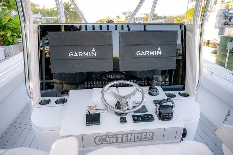 Slide: The Image of 2020 Contender 44 ST boat helm with dual Garmin displays and modern controls. - 5