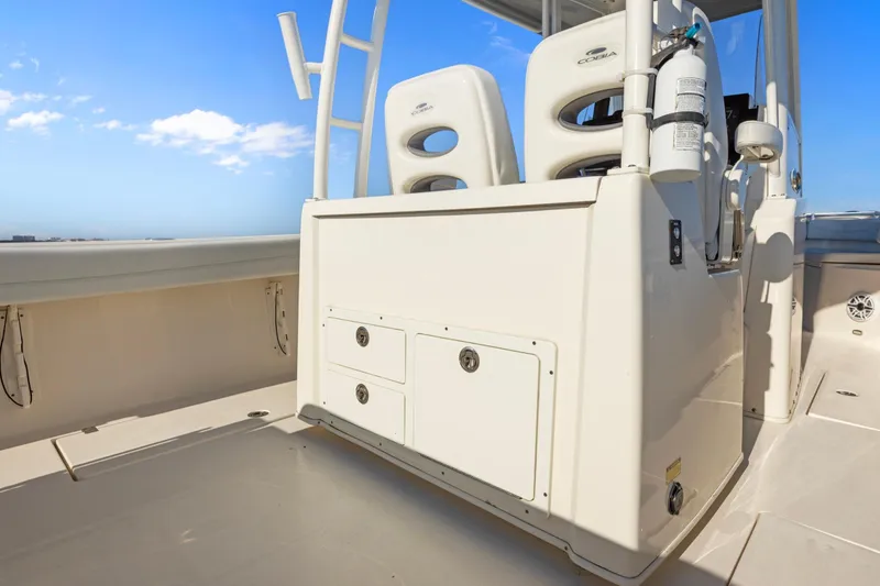 Slide: The Image of 2023 Cobia 301 Center Console boat interior with seating and storage compartments. - 12