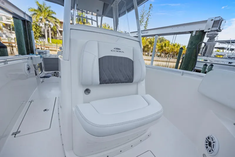 Slide: The Image of 2023 Cobia 301 Center Console boat interior with cushioned seating and sleek design. - 16