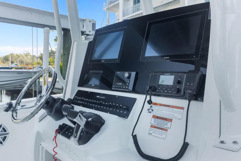 Slide: The Image of 2023 Cobia 301 Center Console helm with dual Garmin displays and controls. - 20