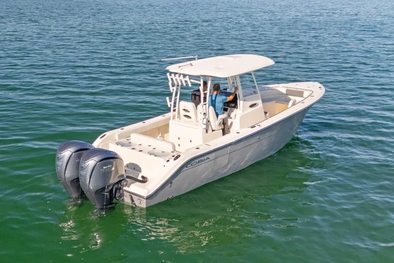 Slide: The Image of 2023 Cobia 301 Center Console boat cruising on open water. - 4