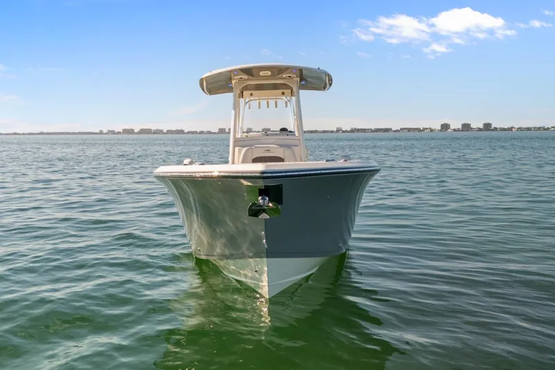 Slide: The Image of 2023 Cobia 301 Center Console boat on calm water under clear sky. - 6