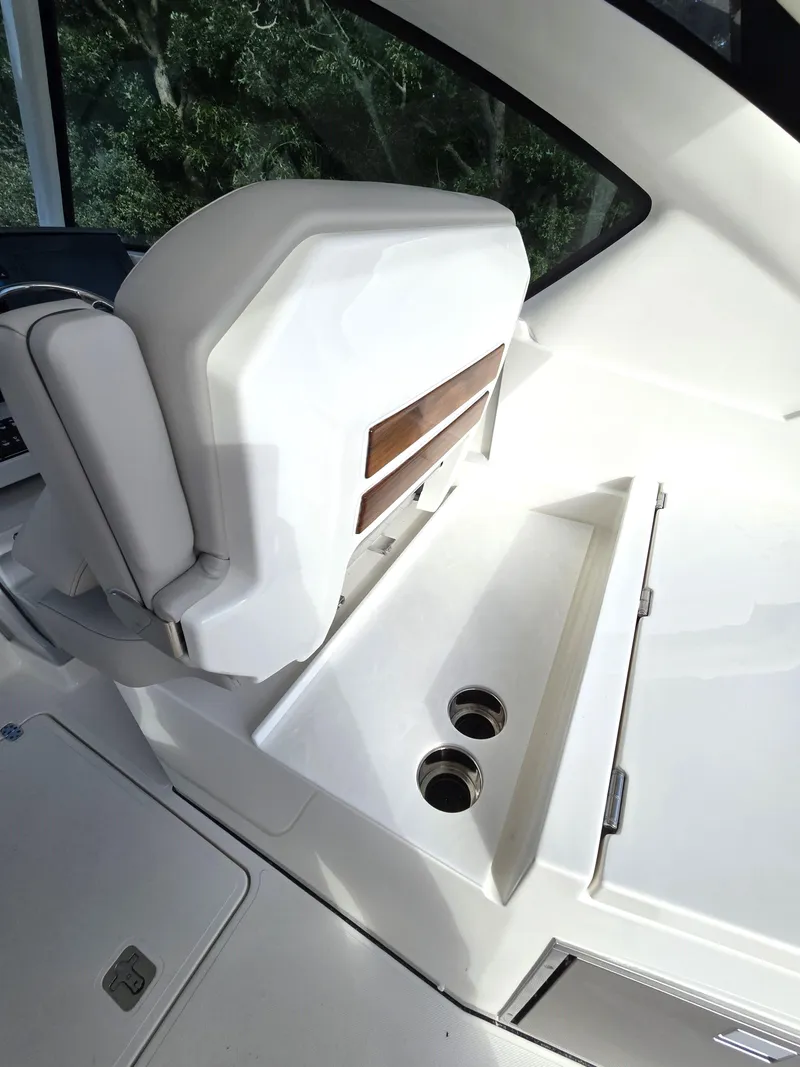 Slide: The Image of 2025 Pursuit DC 326 boat interior with sleek white seating and cup holders. - 12