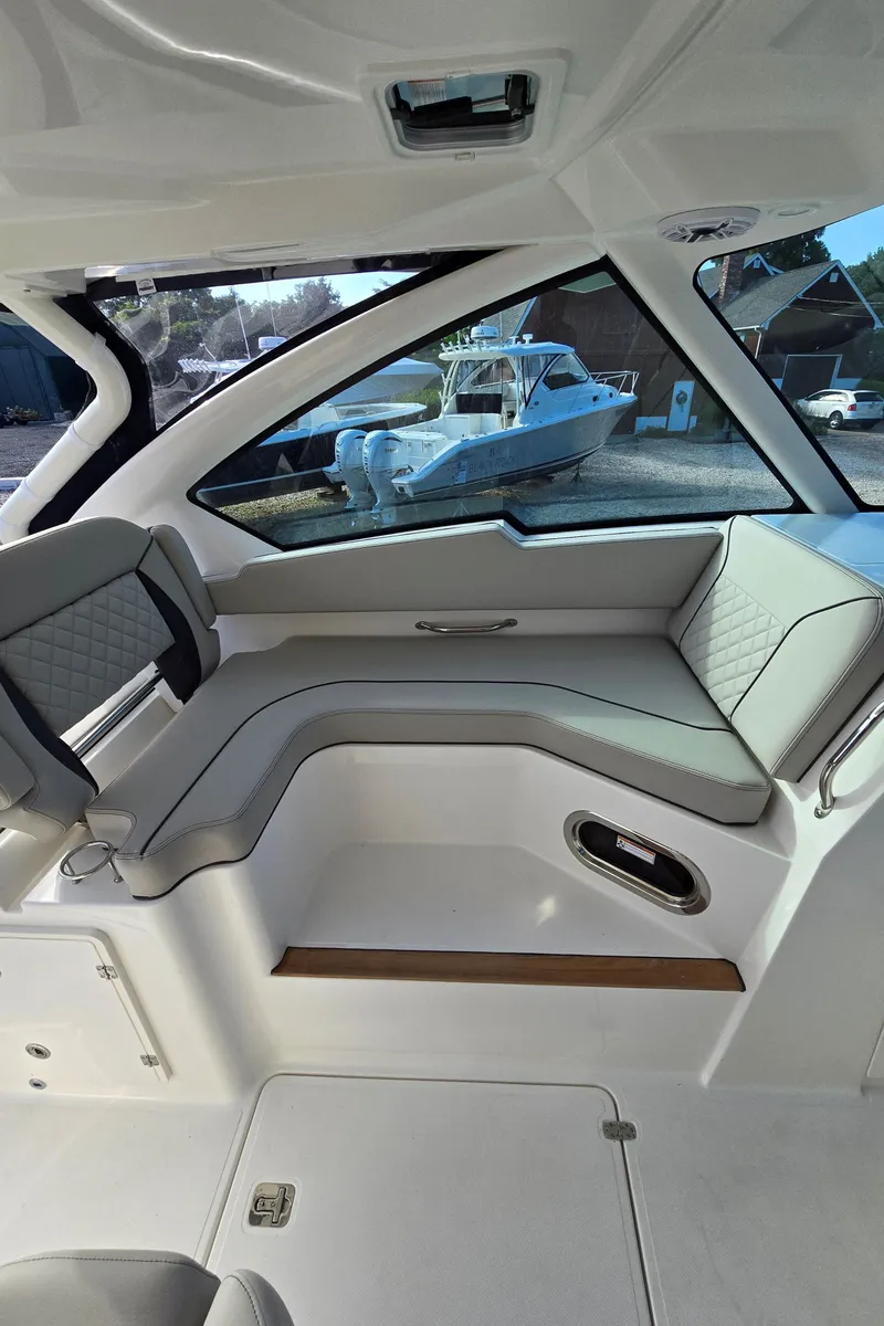 Slide: The Image of Interior of 2025 Pursuit DC 326 boat with sleek seating and modern design. - 15