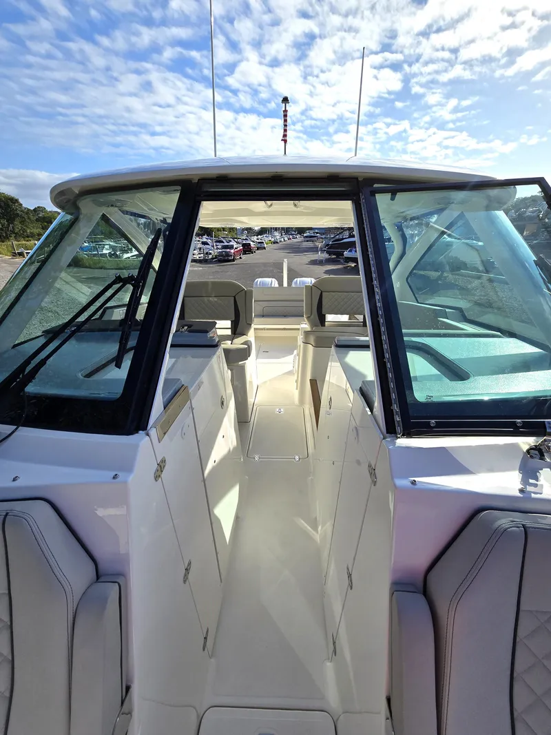 Slide: The Image of 2025 Pursuit DC 326 boat interior with seating and clear sky view. - 17