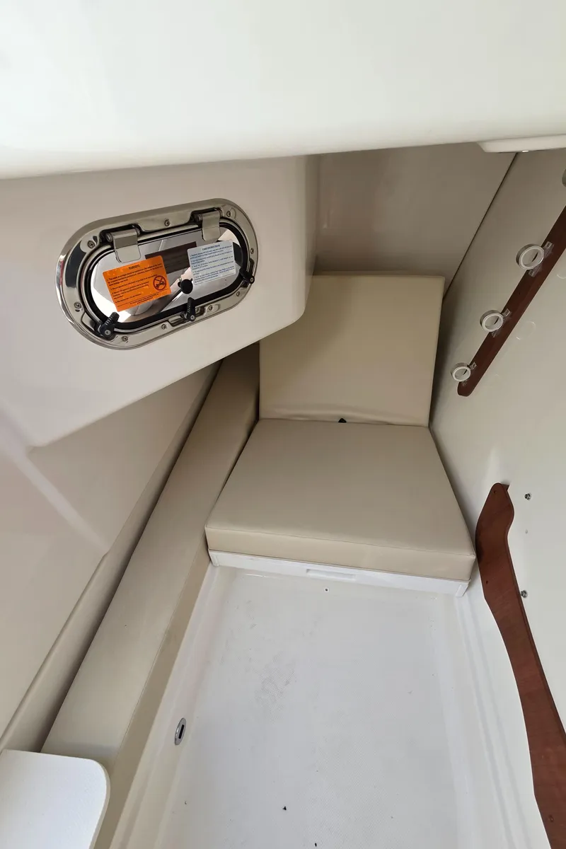Slide: The Image of Interior cabin of 2025 Pursuit DC 326 boat with seating and porthole. - 19
