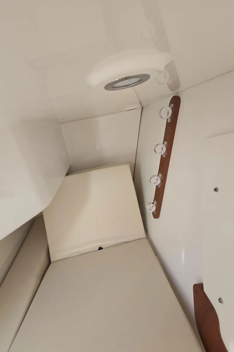Slide: The Image of Interior cabin of 2025 Pursuit DC 326 boat with seating and lighting. - 20