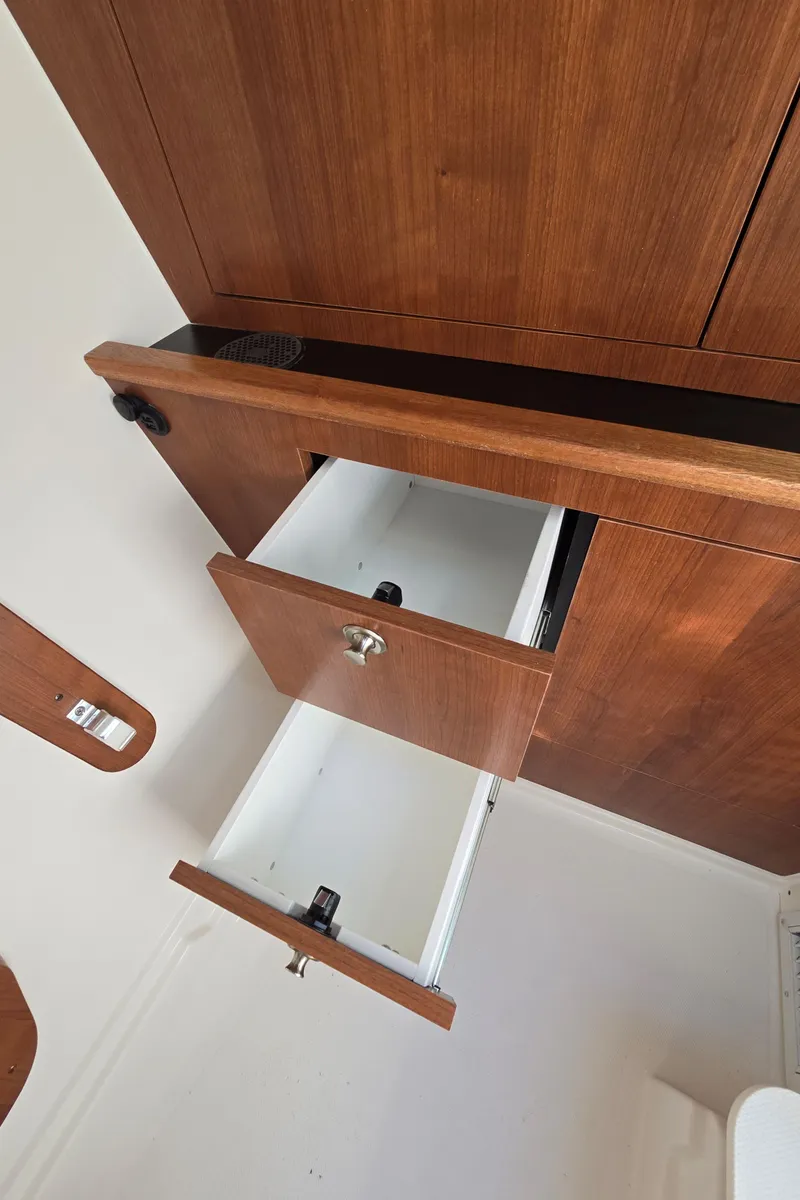 Slide: The Image of Open wooden cabinet drawers in a Pursuit DC 326, 2025 model. - 26