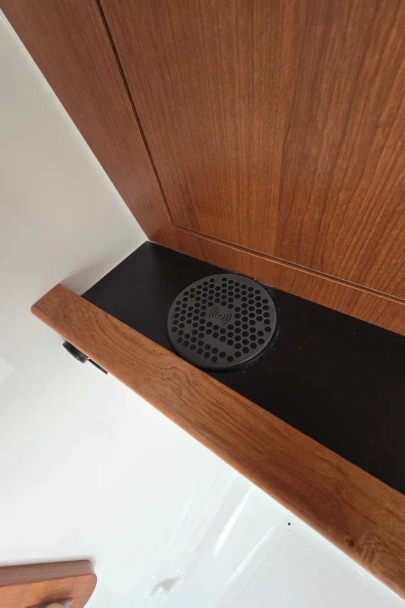 Slide: The Image of Wooden interior detail of 2025 Pursuit DC 326 boat with speaker. - 27