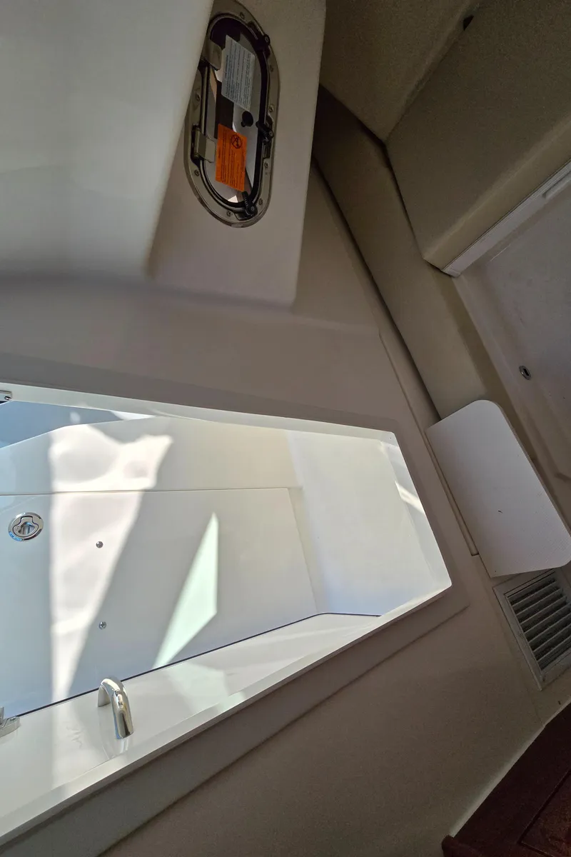 Slide: The Image of Interior view of 2025 Pursuit DC 326 boat cabin with sleek design. - 28
