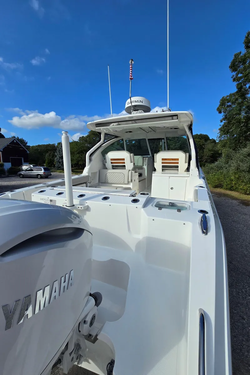 Slide: The Image of 2025 Pursuit DC 326 boat with Yamaha engine, docked under clear blue sky. - 3