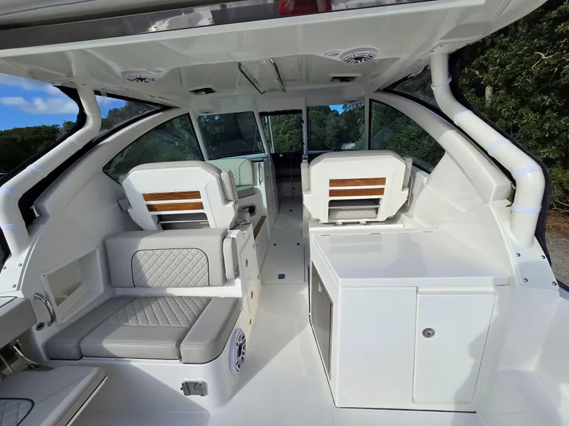 Slide: The Image of 2025 Pursuit DC 326 boat interior with modern seating and sleek design. - 5