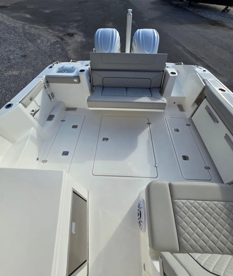 Slide: The Image of 2025 Pursuit DC 326 boat interior with seating and dual engines. - 6
