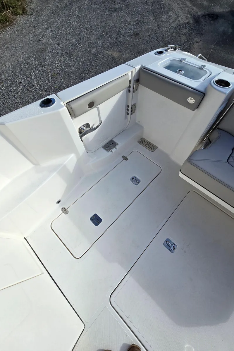 Slide: The Image of 2025 Pursuit DC 326 boat deck with storage compartments and sink. - 7