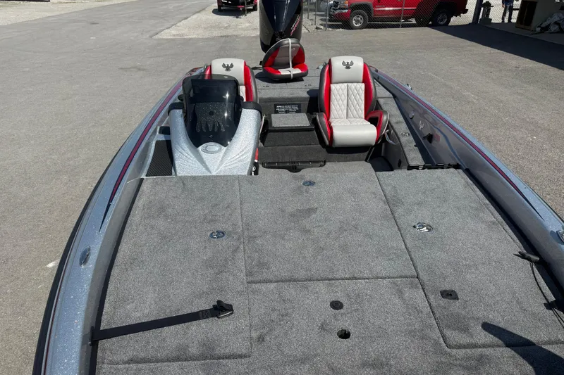 Slide: The Image of 2026 Phoenix 819 ZXL boat interior with gray carpet and red-accented seats. - 13