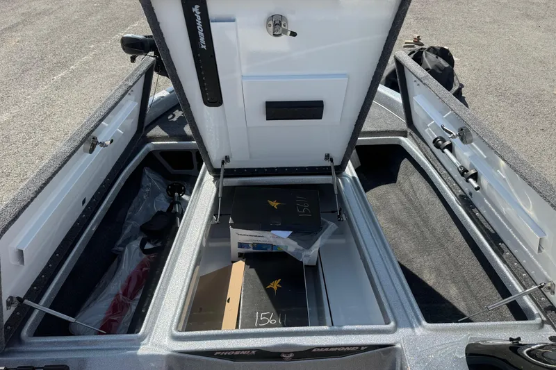 Slide: The Image of Open storage compartment of 2026 Phoenix 819 ZXL boat, showcasing interior space and equipment. - 14