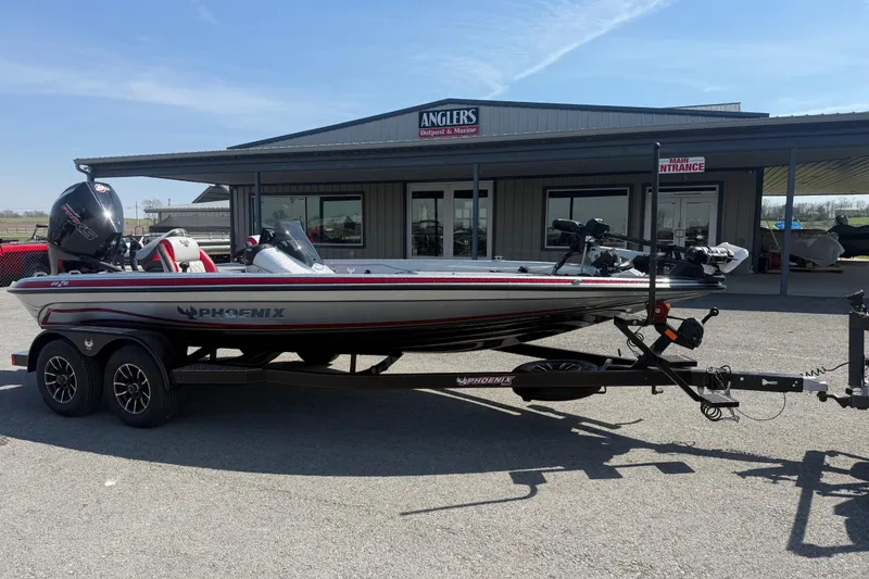 Slide: The Image of 2026 Phoenix 819 ZXL boat on trailer outside Anglers store. - 2
