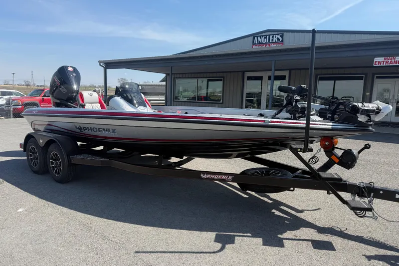 Slide: The Image of 2026 Phoenix 819 ZXL boat on trailer outside Anglers store, sunny day. - 3