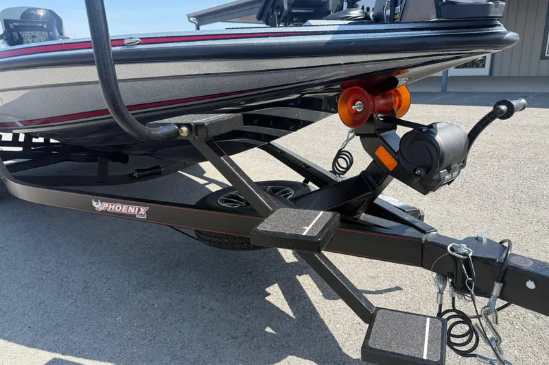 Slide: The Image of 2026 Phoenix 819 ZXL boat trailer with winch and roller on pavement. - 4