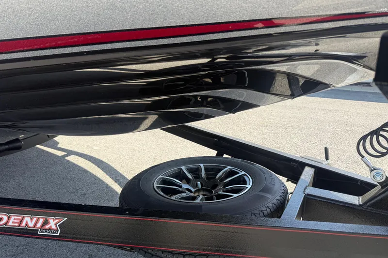 Slide: The Image of Trailer and hull of a 2026 Phoenix 819 ZXL boat, showcasing sleek design and wheel detail. - 5