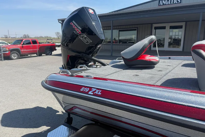 Slide: The Image of 2026 Phoenix 819 ZXL boat with Mercury Pro XS engine, parked near a dealership. - 7