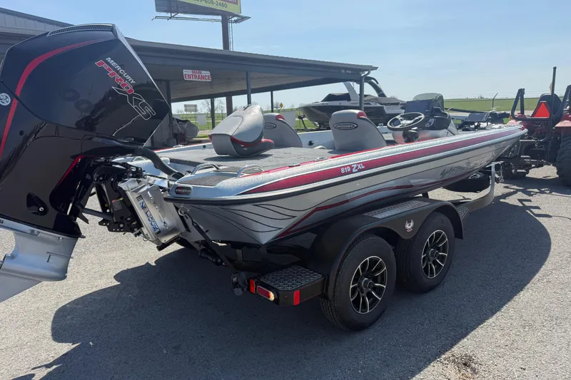 Slide: The Image of 2026 Phoenix 819 ZXL boat with Mercury Pro XS engine, parked outdoors. - 8