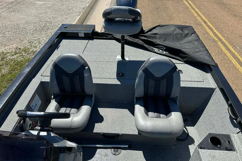 Slide: The Image of 2020 G3 Sportsman 1610 Camo boat interior with three gray seats and steering console. - 14