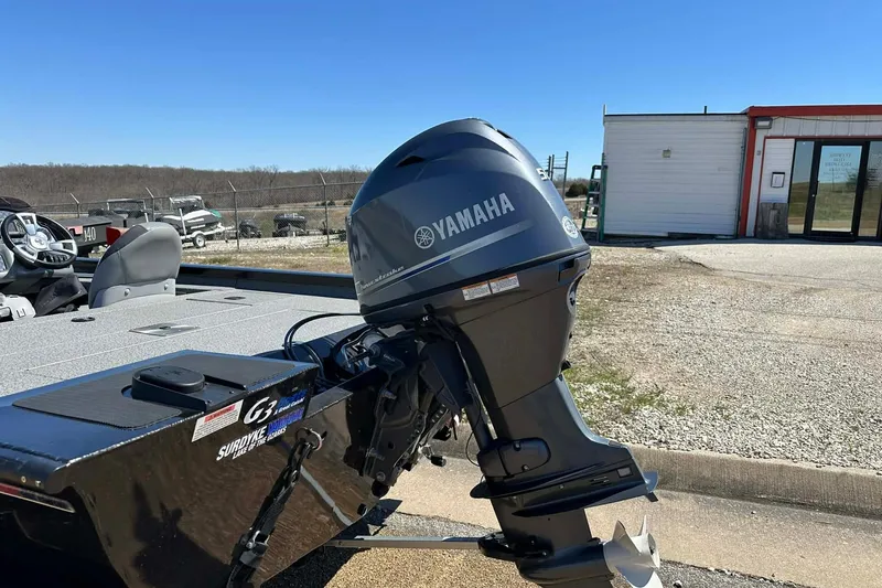 Slide: The Image of 2020 G3 Sportsman 1610 Camo boat with Yamaha outboard motor in outdoor setting. - 16