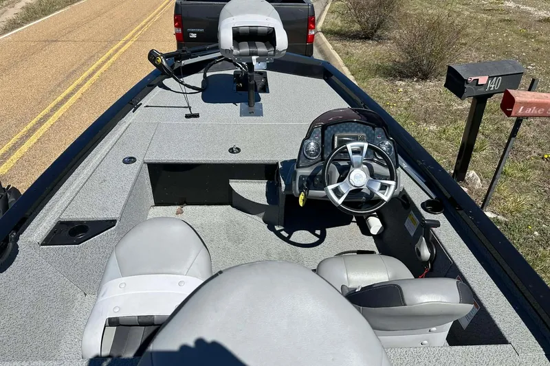 Slide: The Image of 2020 G3 Sportsman 1610 Camo boat interior with steering wheel and seating. - 2