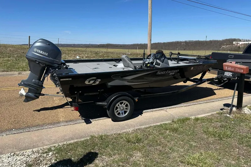Slide: The Image of 2020 G3 Sportsman 1610 Camo boat with Yamaha motor on trailer, parked roadside. - 24