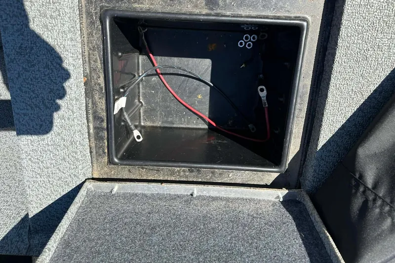Slide: The Image of Open battery compartment of 2020 G3 Sportsman 1610 Camo boat, showing wiring and connectors. - 5