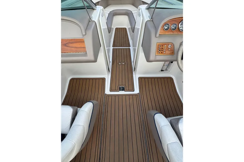 Slide: The Image of Interior of a 2000 Cobalt 226 boat with wood paneling and dashboard controls. - 14