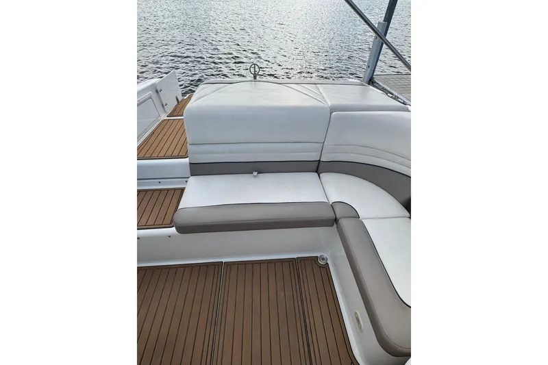 Slide: The Image of Cobalt 226 boat interior with white and beige seating, wooden deck, 2000 model. - 16