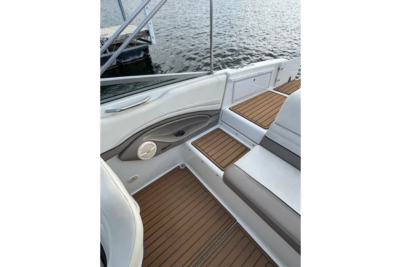 Slide: The Image of Interior of 2000 Cobalt 226 boat with teak flooring and white seating. - 17