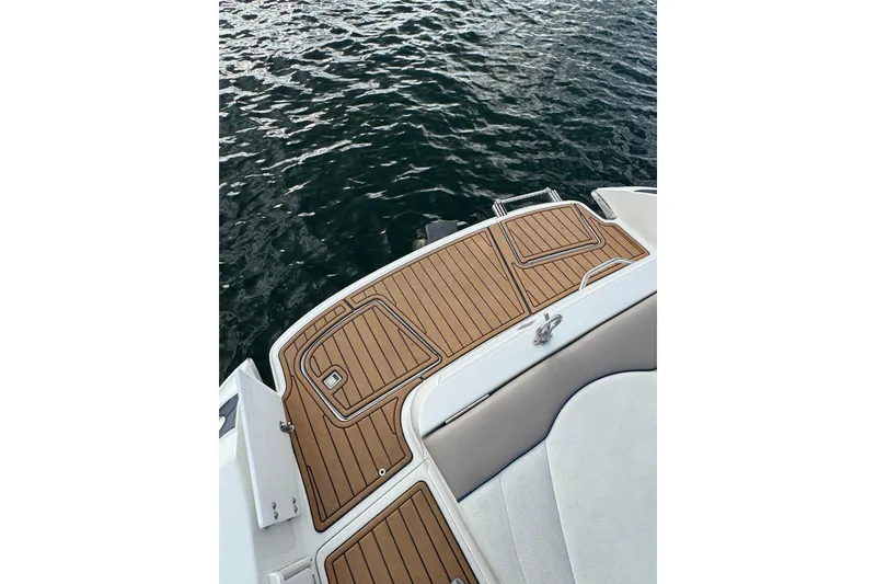 Slide: The Image of Teak deck of a 2000 Cobalt 226 boat with water in the background. - 18