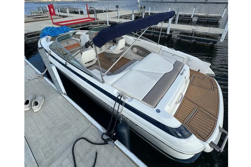 Slide: The Image of 2000 Cobalt 226 boat docked, featuring a sleek design and spacious seating area. - 5