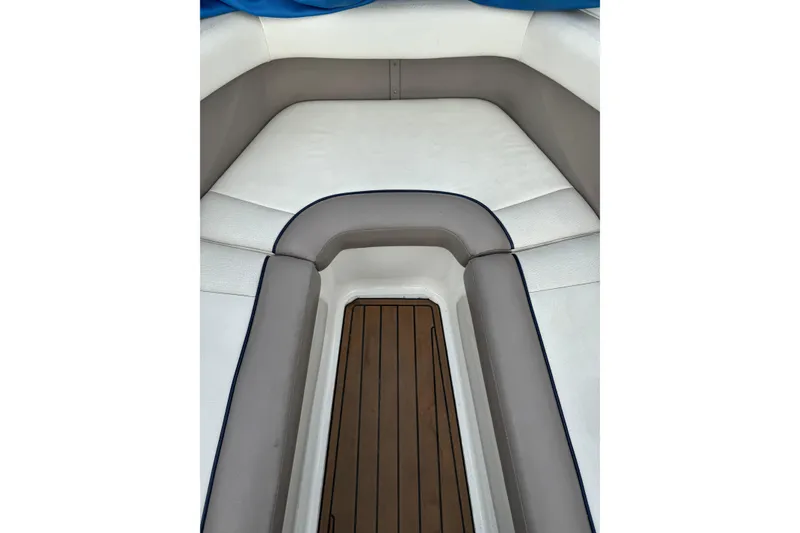Slide: The Image of Interior of a 2000 Cobalt 226 boat with cushioned seating and wooden flooring. - 6