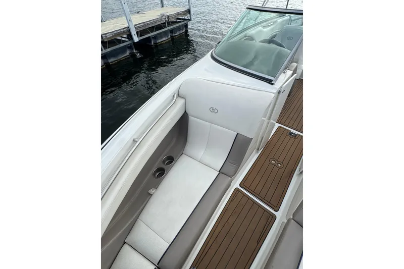 Slide: The Image of Interior of a 2000 Cobalt 226 boat with white seating and wooden deck accents. - 8