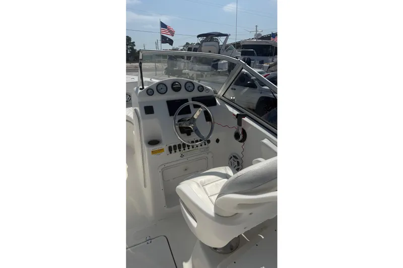Slide: The Image of 2012 Sea Fox 216 Dual Console boat interior with steering wheel and dashboard controls. - 11