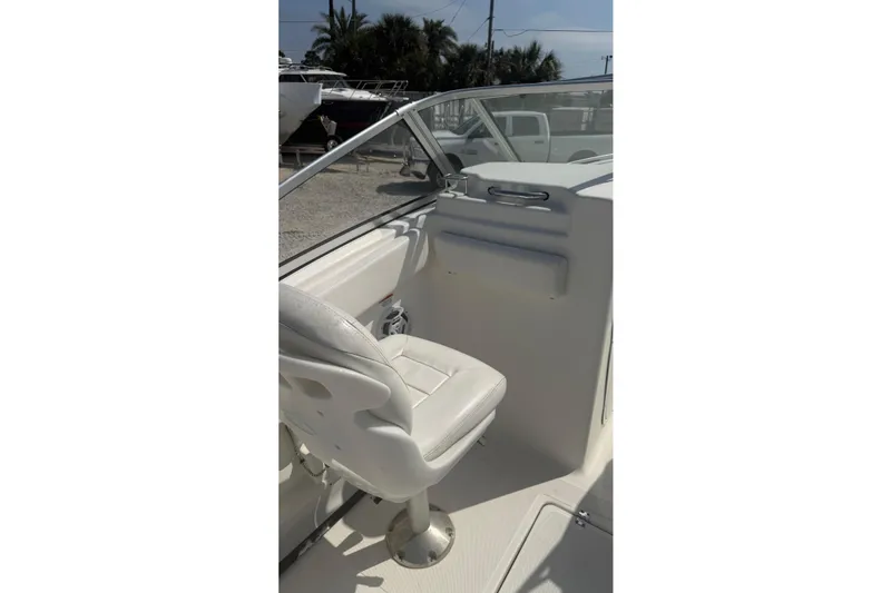 Slide: The Image of 2012 Sea Fox 216 Dual Console boat interior with white seating and windshield. - 12