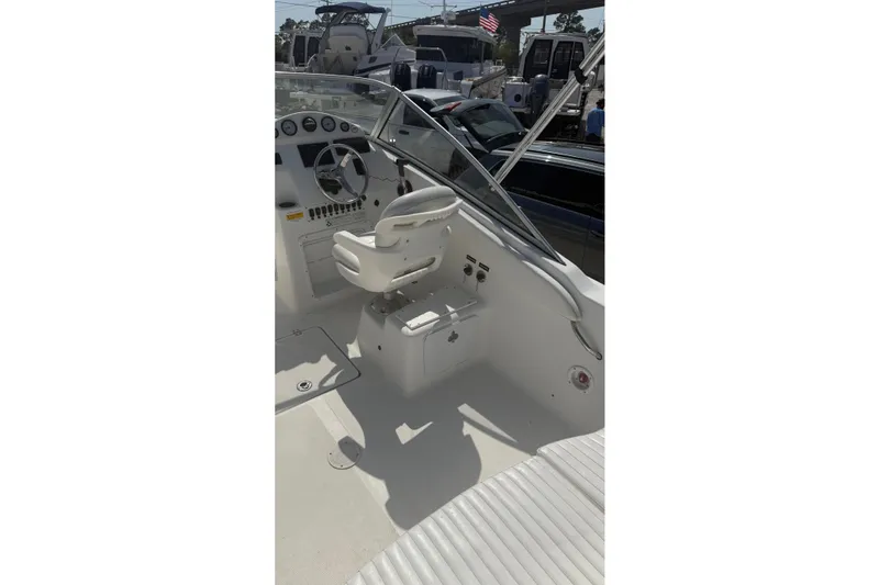 Slide: The Image of Interior view of a 2012 Sea Fox 216 Dual Console boat, featuring steering wheel and seating. - 14